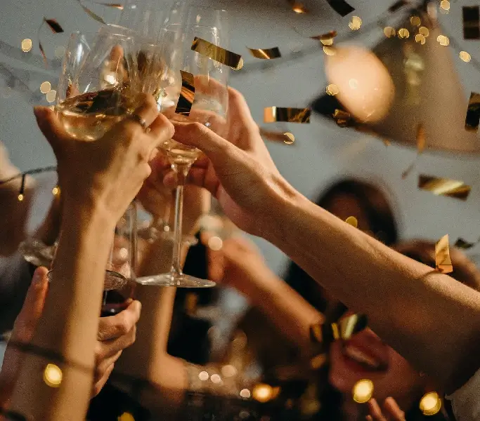 a group of people clinking wine glasses